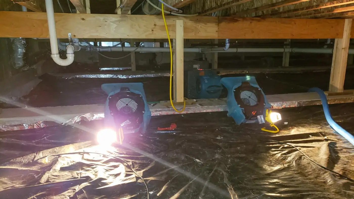 Drying equipment running under a floor in a wet crawl space